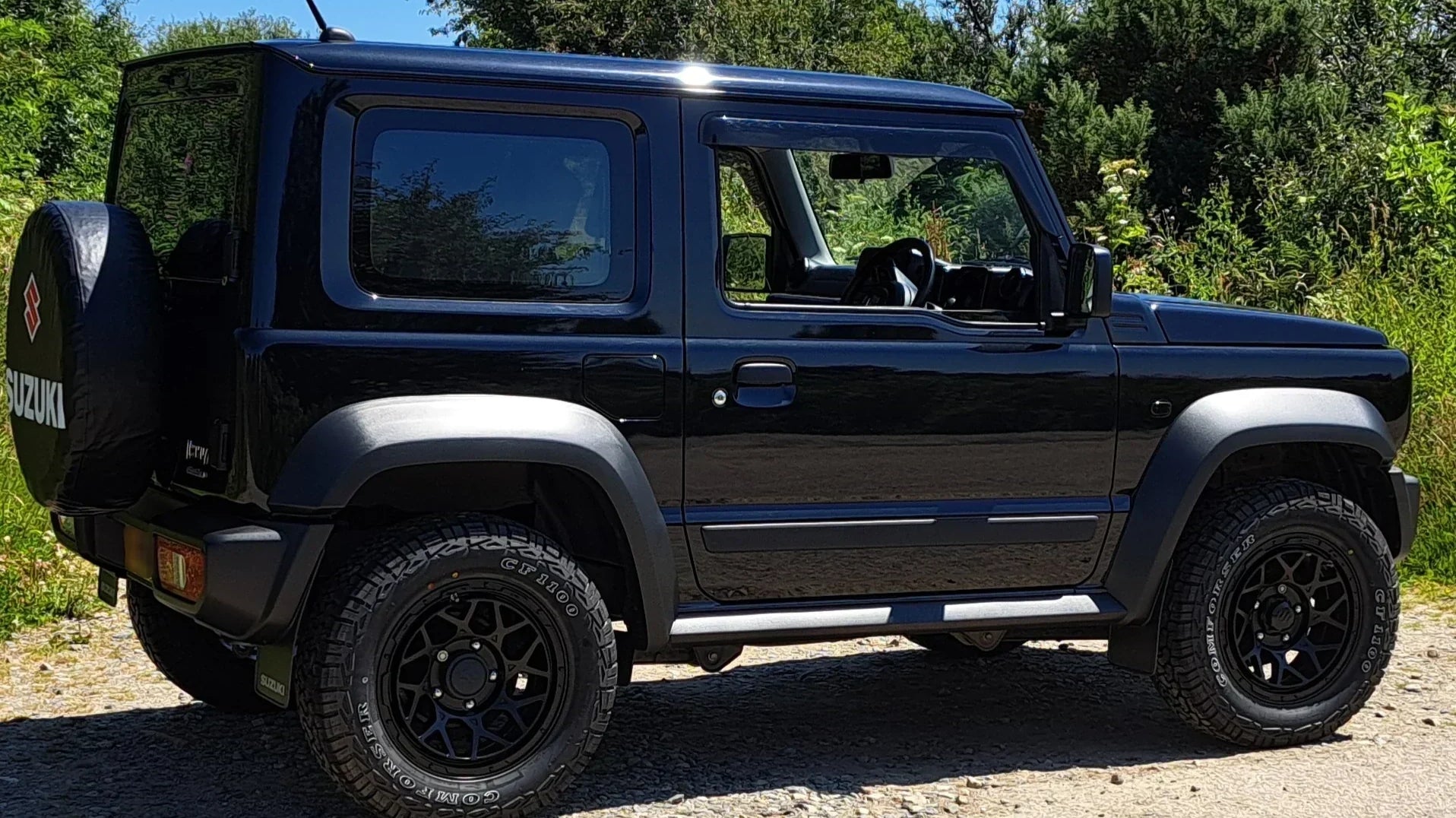 Black Suzuki Jimny (2018+) with Satin Black Magpie M-01 wheels and Comforser CF1100 tyres in a 215/70R16 size