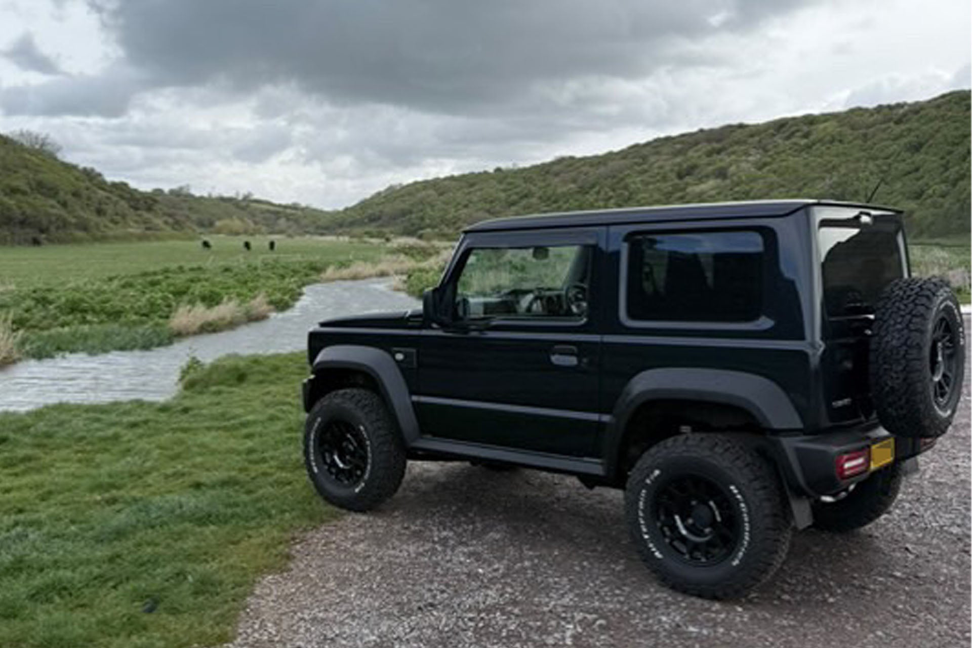 Black Suzuki Jimny 2018+ fitted with Retro Grille and Tactical Grill badge as well as various JIMNYSTYLE LED Lighting accessories