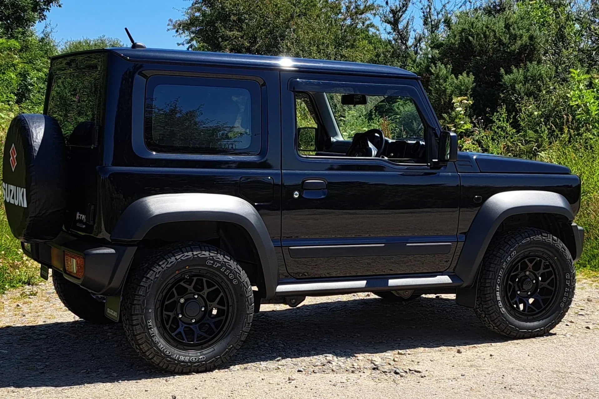 Black Suzuki Jimny (2018+) with Satin Black Magpie M-01 wheels and Comforser CF1100 tyres in a 215/70R16 size