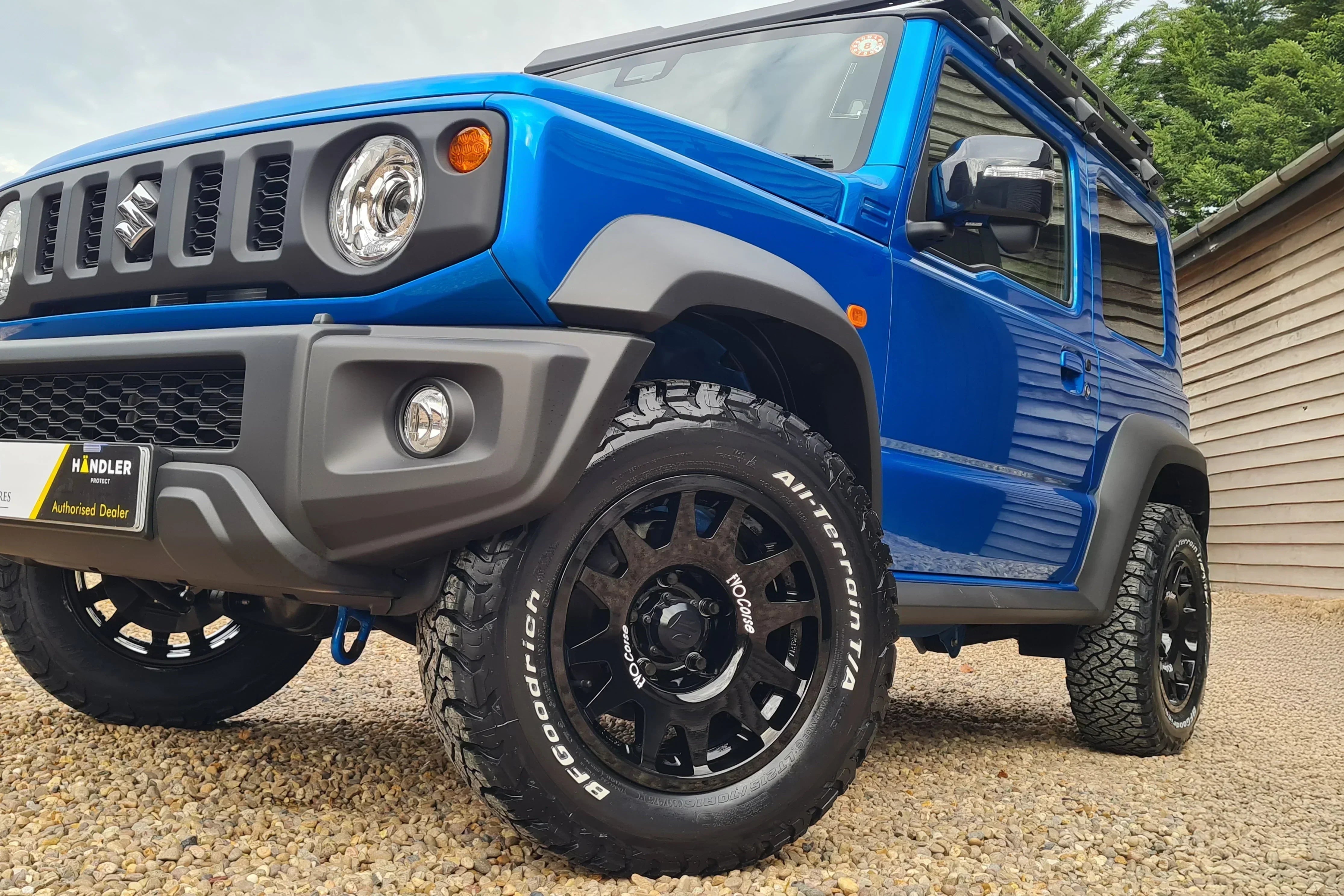Suzuki Jimny (2018+) with 16" EVO Corse DakarZero wheels in Glossy Black and BF Goodrich KO3 tyres in a 215/70R16 size.