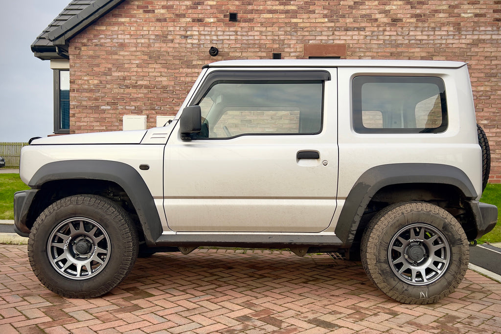 Silver Suzuki Jimny fitted with Anthracite EVO Corse DakarZero Wheels