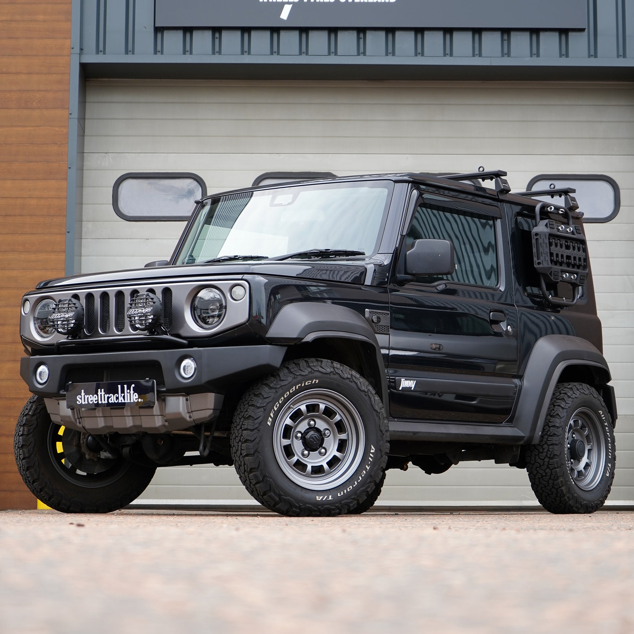 A painted APIO Front Bumper fitted onto a black Suzuki Jimny. This is a Body Kit Modification